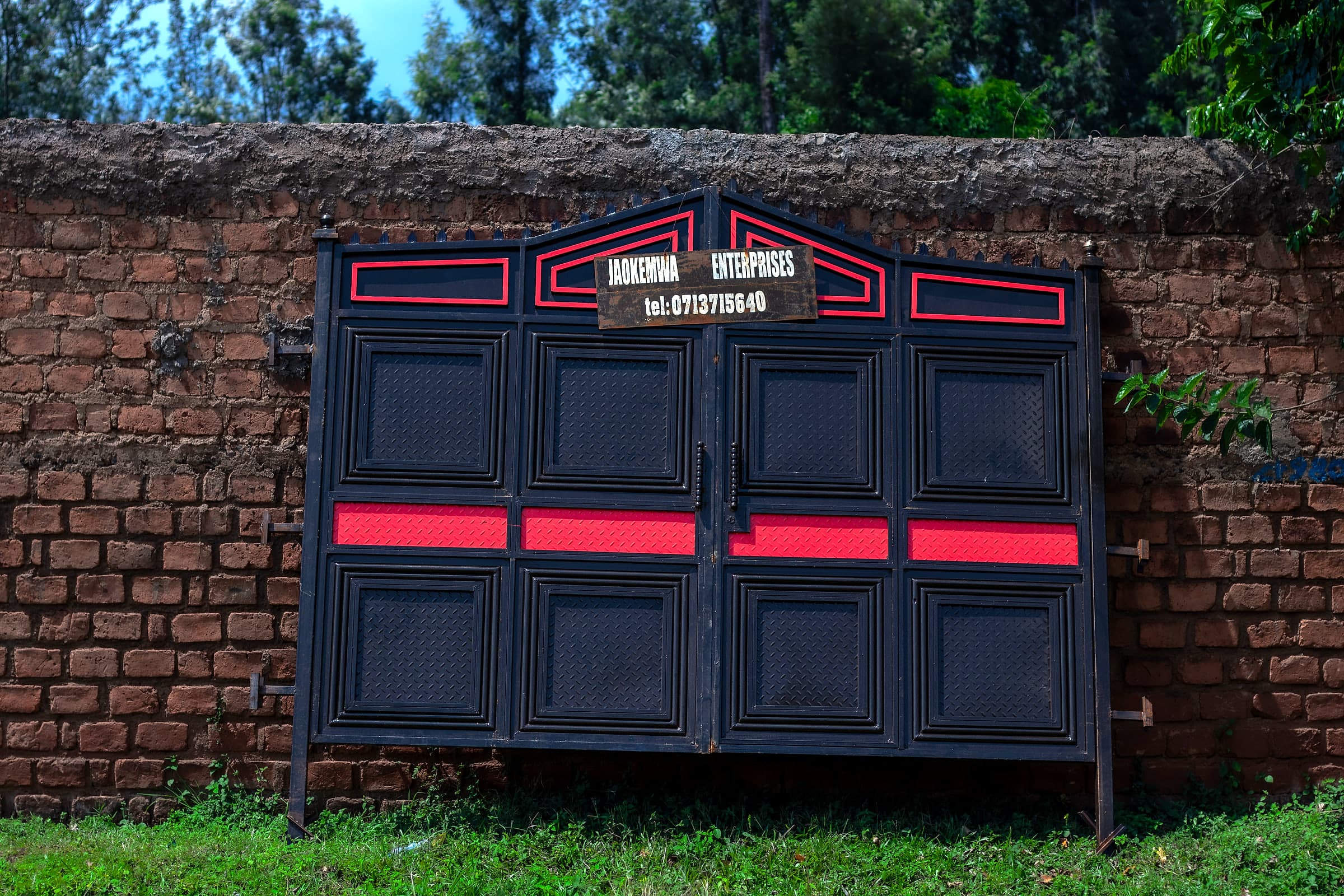 Black & Red Panel Gate on Brick Wall