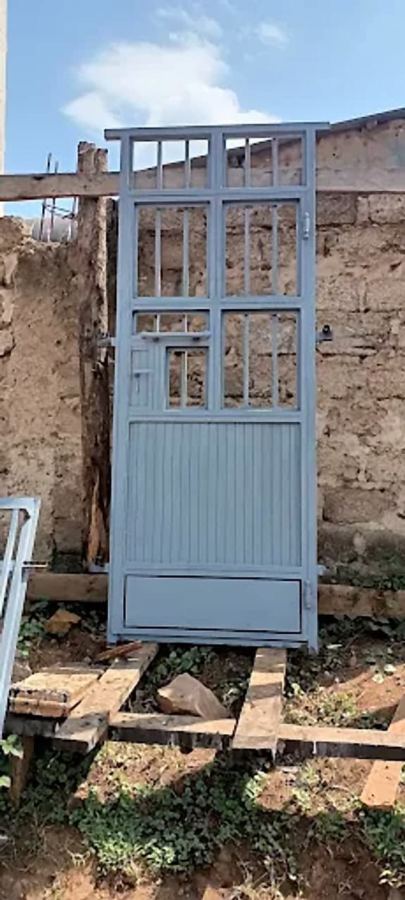 Grill-Top Security Door in Stone Opening